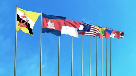 Asean Economic Community flags on the blue sky background