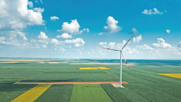 Aerial view of wind turbines on modern wind farm from drone pov, high angle view of innovative sustainable resources technology
