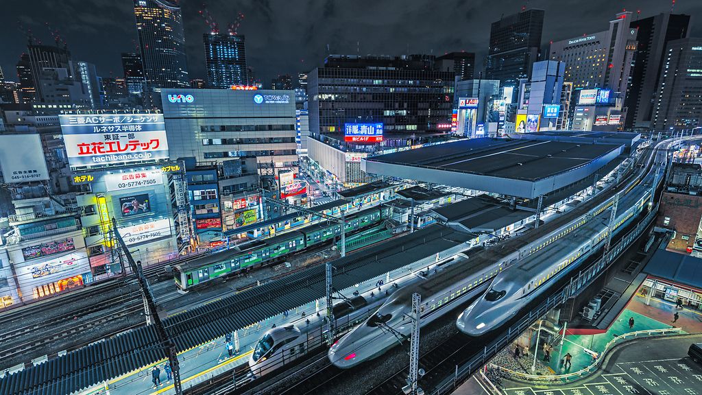 Tokyo Shinkansen bullet trains passing at night at Shimbashi Station