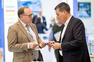 Brexit expert Richard Todd (on the left) exchanging business cards with an interested visitor.
