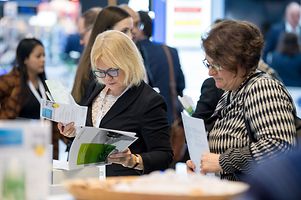 Interested audience studies our publication portfolio and program @ GTAI booth.