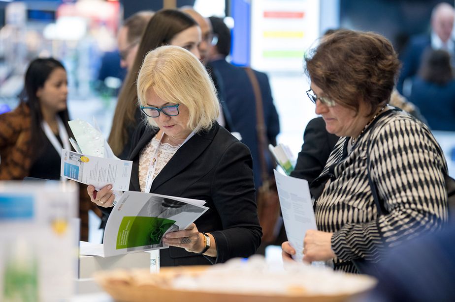 Interested audience studies our publication portfolio and program @ GTAI booth.