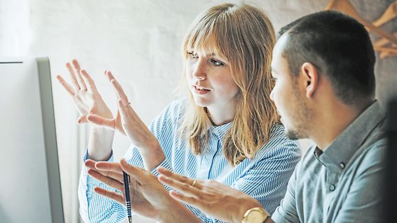 Besprechung Planung | © GettyImages/Tom Werner Two startup business colleagues problem-solving at a computer together in the office.