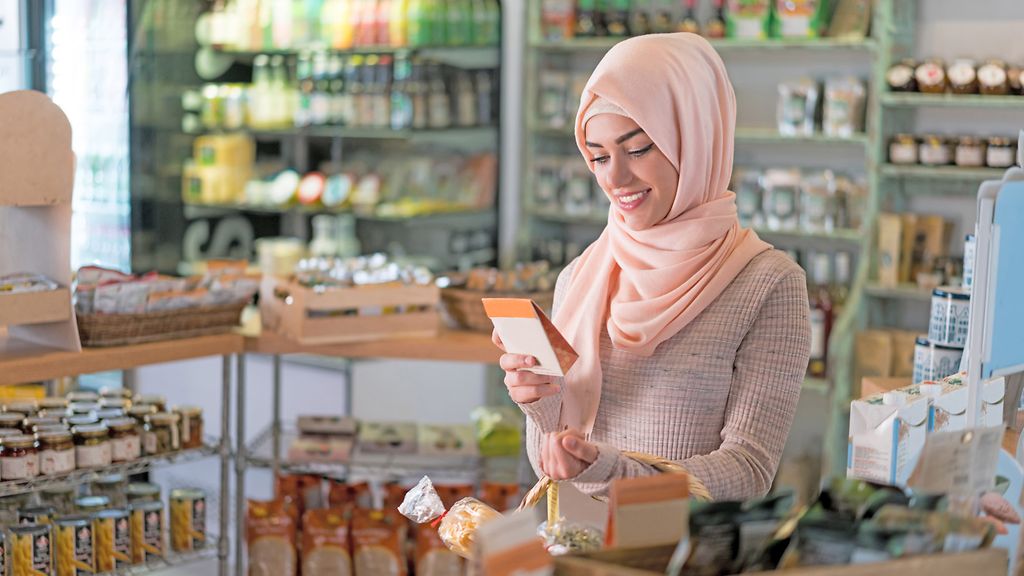 Portrait of a Muslim woman shopping at the grocery shop and looking very happy