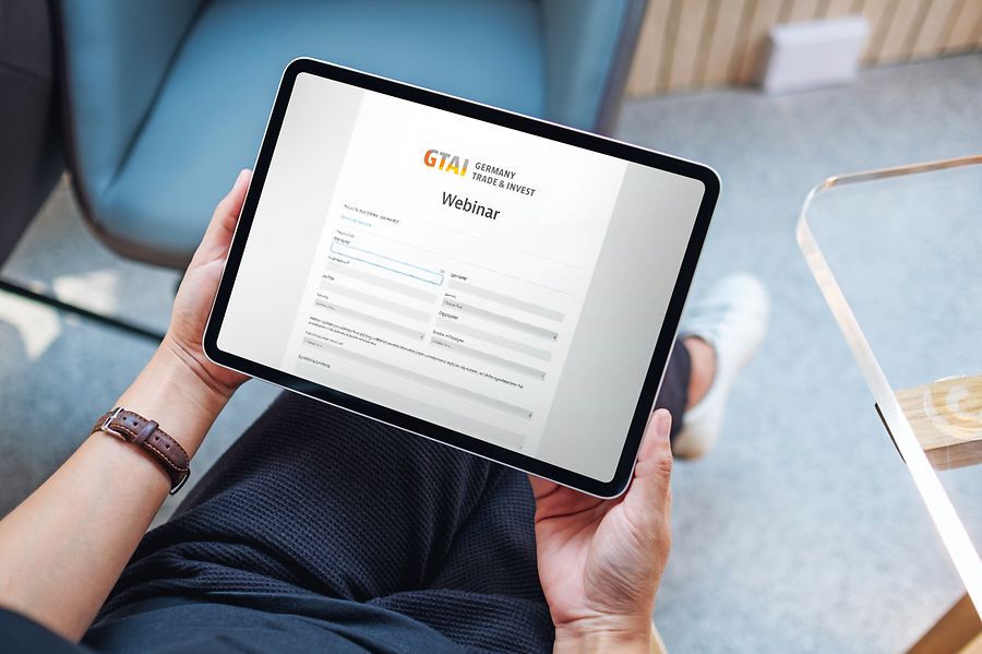 Top view mockup image of a woman holding digital tablet with blank white desktop screen in cafe - Adobe_490854929