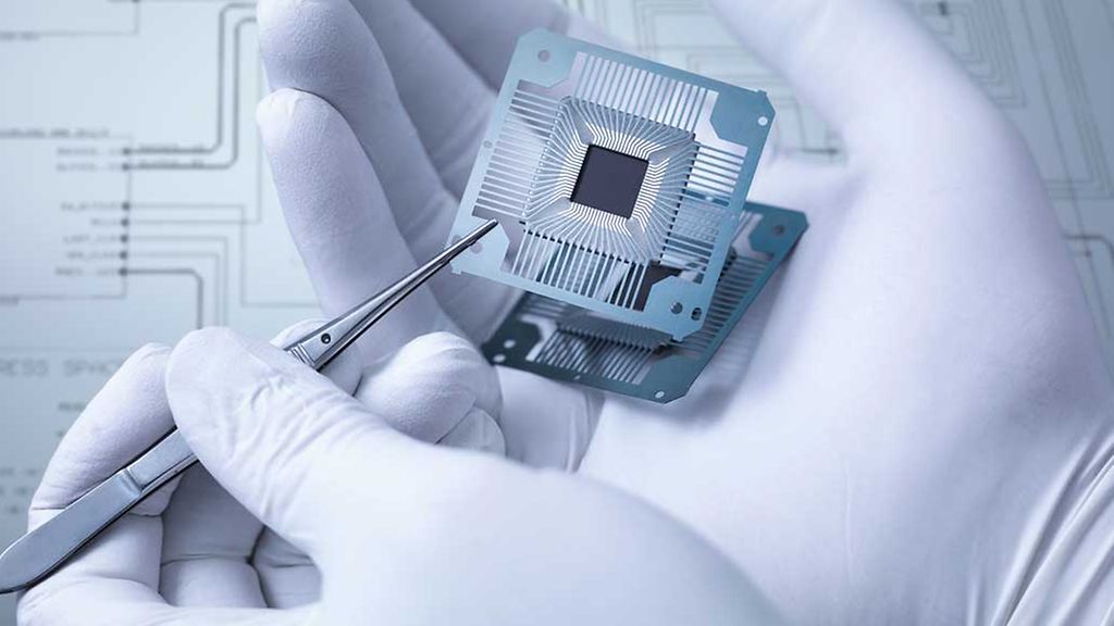 Electronic components held in hand in laboratory, close up
