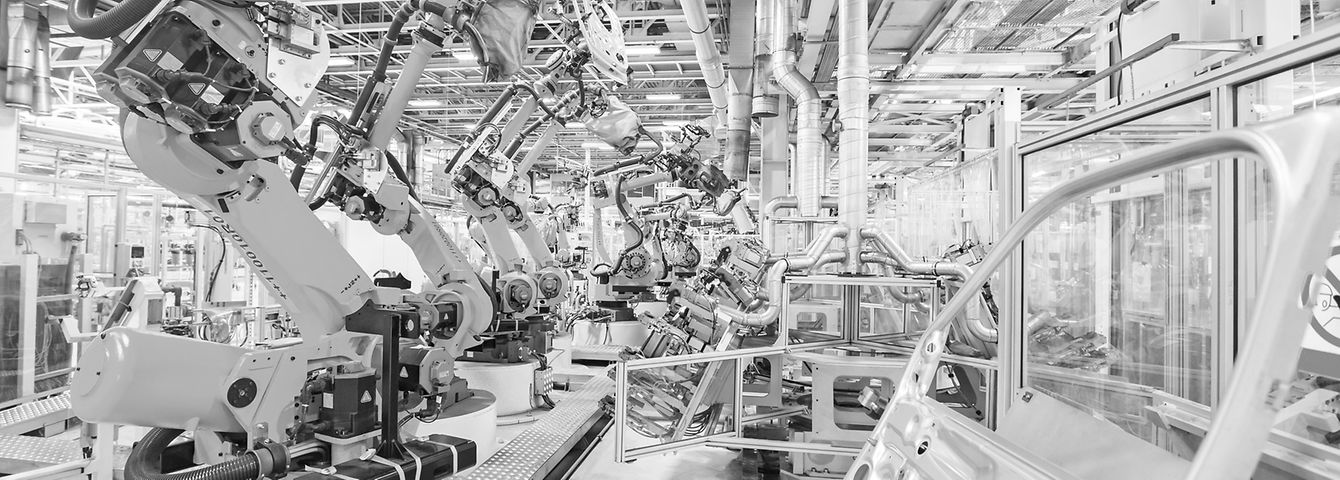 robotic arms in a car plant