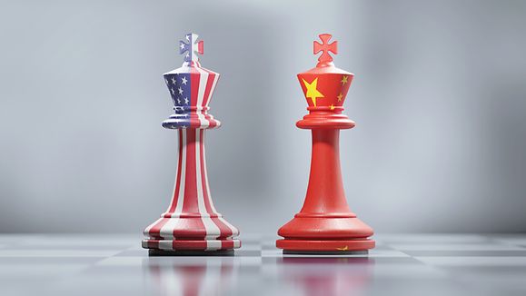 Zwei Schachfiguren bemalt mit US-Flagge und chinesischer Flagge