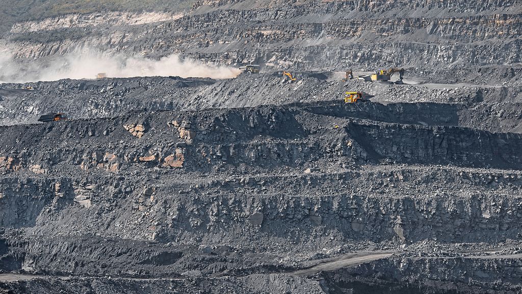 Geological section of soil, layers of coal and rock. Overburden open mine anthracite. Dark texture black color.