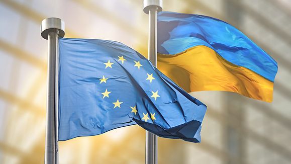 Flags of European Union and Ukraine against European Parliament bulding in Brussels, Belgium