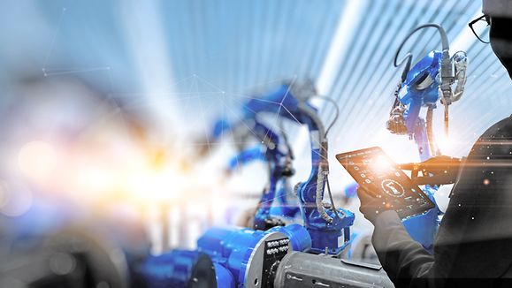 Factory Female Industrial Engineer working with automation robot arms machine in intelligent factory industrial on real time monitoring system software.Digital future manufacture.